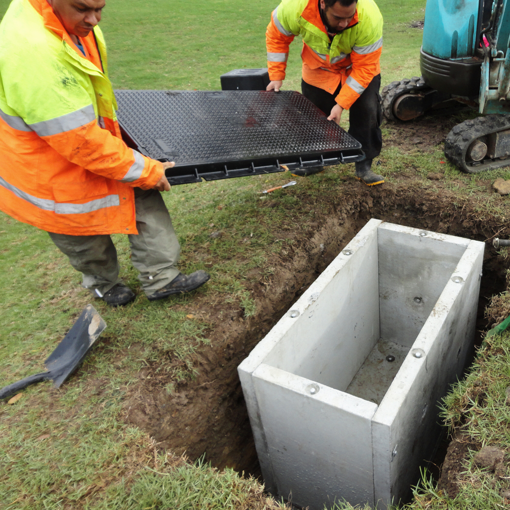 Humes Concrete Telco Pit with Lid being installed